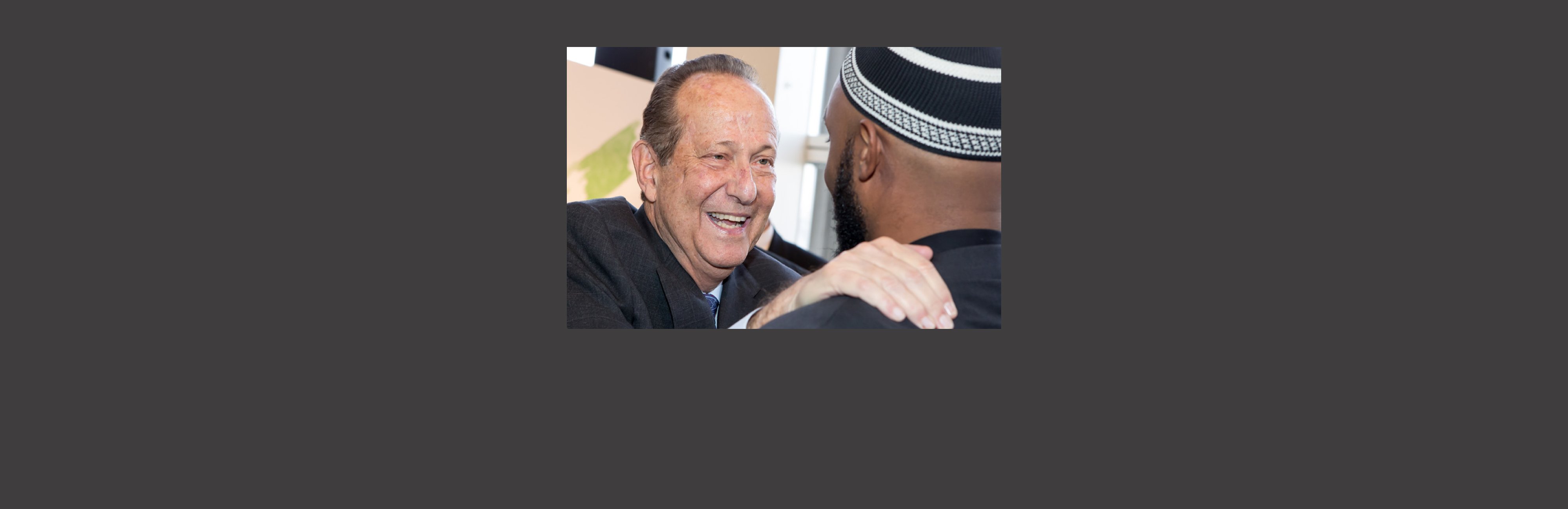 Bruce Corwin greeting an Imam