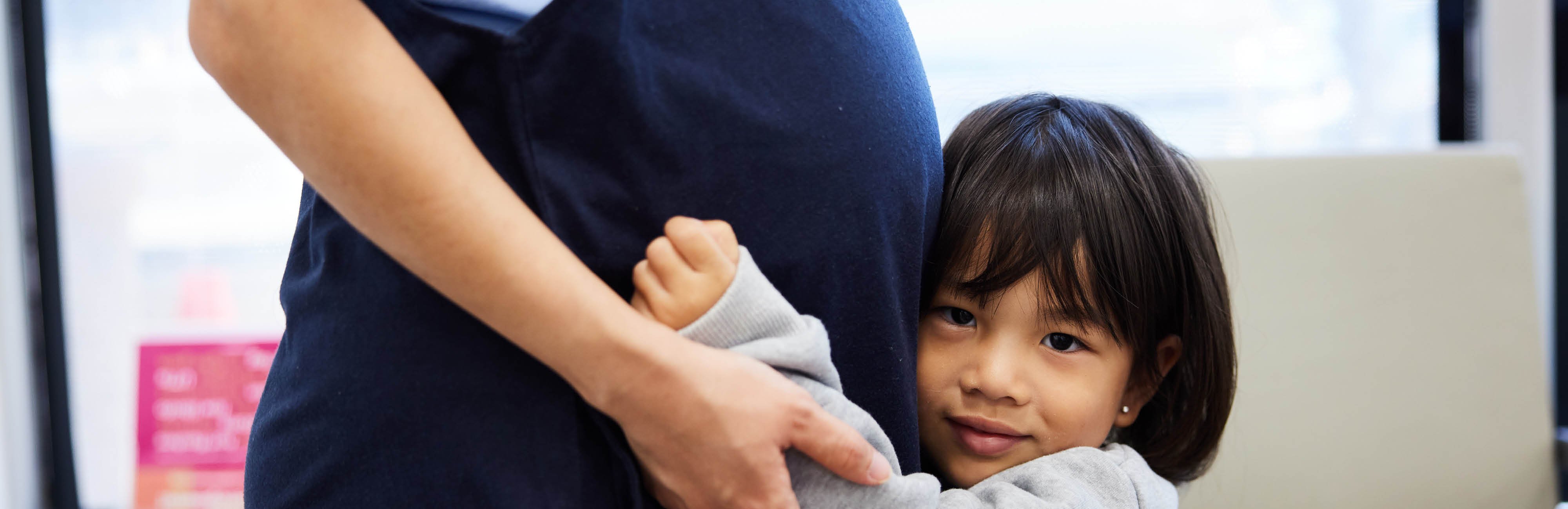 Child hugging pregnant mom