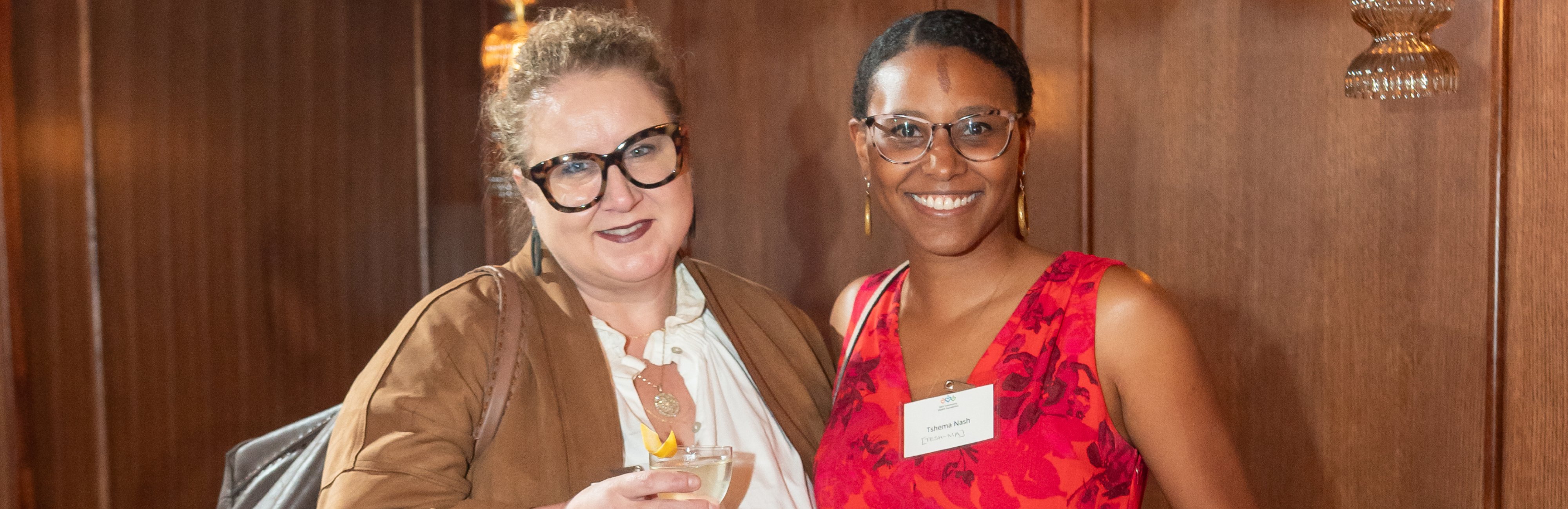 Two women standing together and smiling at the camera at the MLKCHF Spring Inspiration Dinner