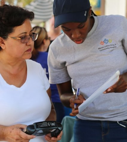 Two women looking at a flyer