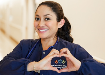 Latina nurse making heart with hands
