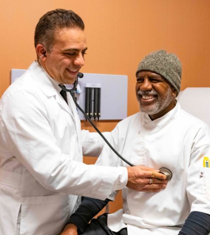 Male physician with a male, African American patient