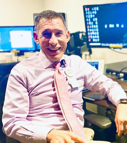 Photo of Dr. Edward Zaragoza sitting at desk and smiling