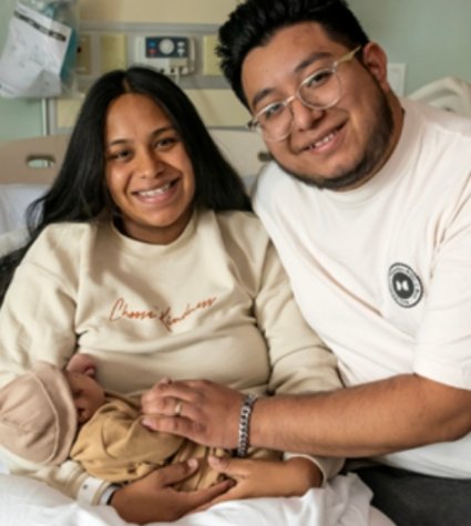 Photo of Hispanic couple with newborn