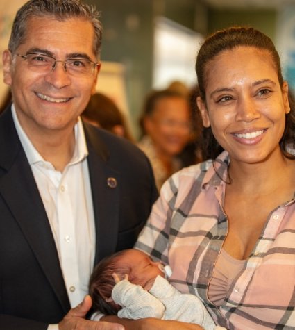 Photo of HHS Sec. Becerra and MLKCH mother and newborn