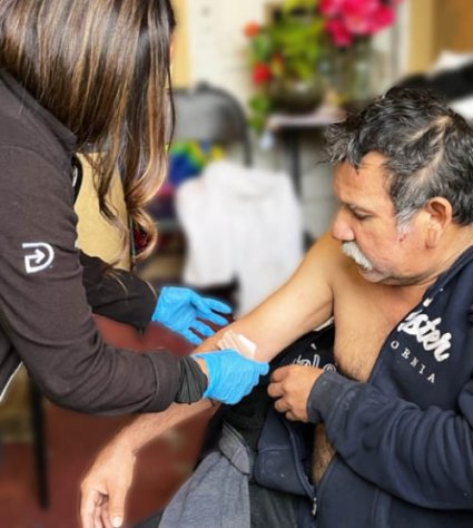 a man getting a bandage out on his arm