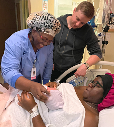 Image of nurse delivering baby