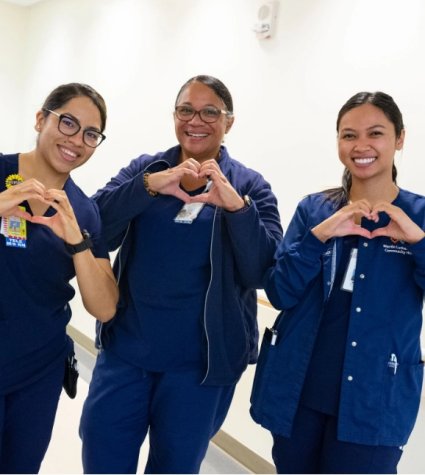 Photo of three nurses making MLKCH hearts