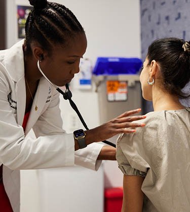 Female doctor performing a check up on a female patient