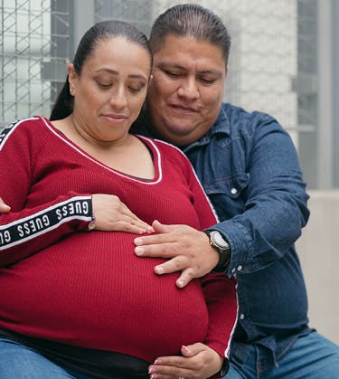 Pregnant woman sitting with husband