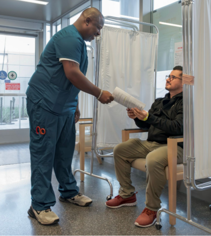 Nurse handing a paper to a patient