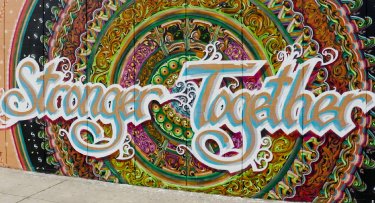 Colorful mural with Stronger Together words