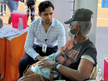 MLKCH Doctor with patient at community event.