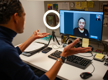 Two people having a conversation via Zoom virtual meeting.