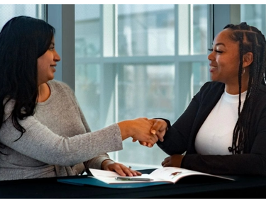 Two people shaking hands.