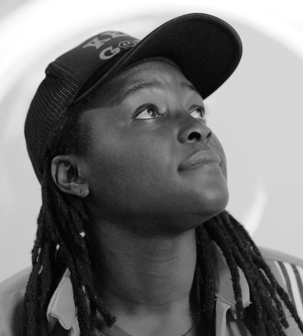 Image of young black woman with hat and braids