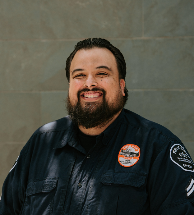 Man smiling in public safety uniform