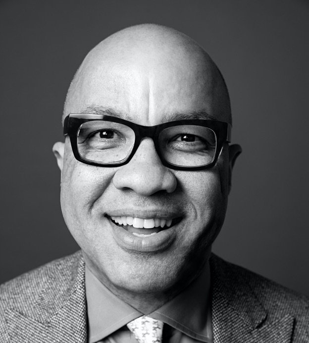 Black and white headshot of Darren Walker, a bald middle-aged Black man with glasses