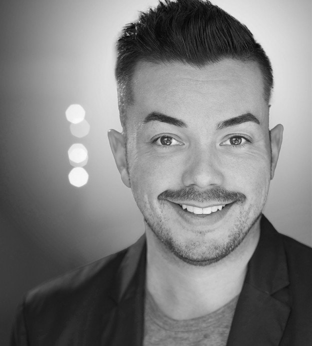 Black and white photo of young Latino man with mustache