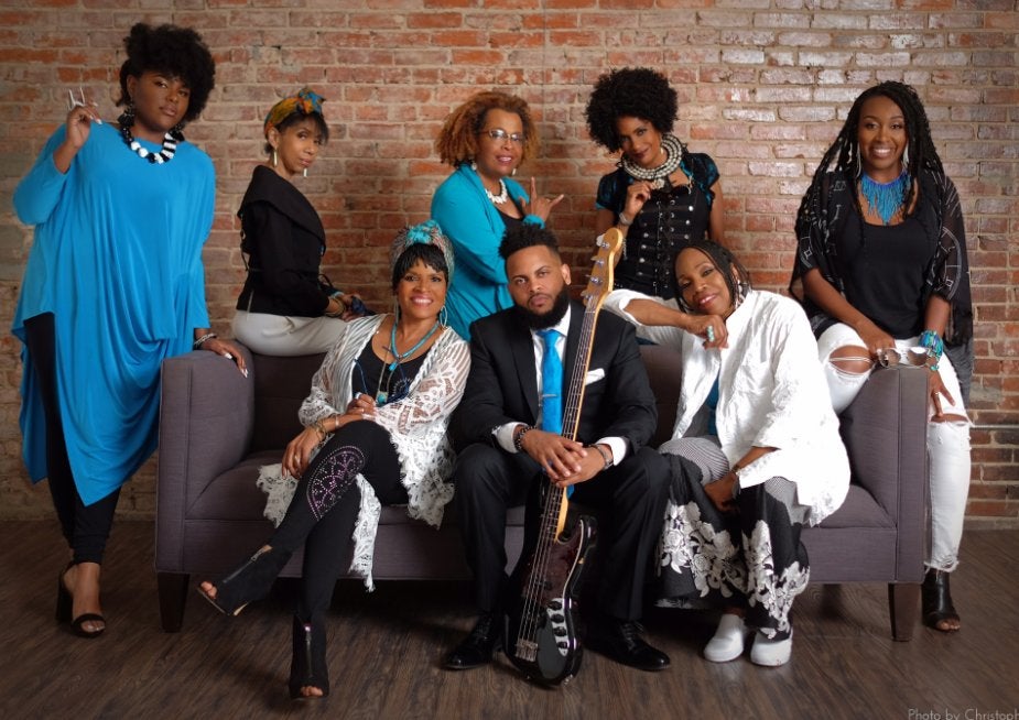 Sweet Honey in the rock band photo, participants sitting and standing together looking at the camera