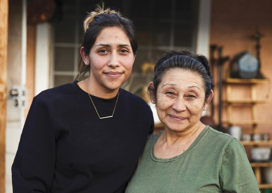 Senior mother and daughter together smiling at the camera
