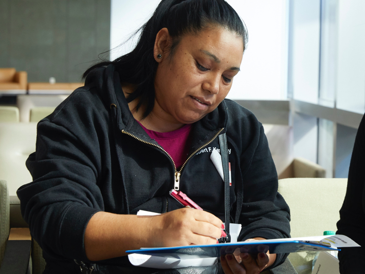 Latina woman filling out a form