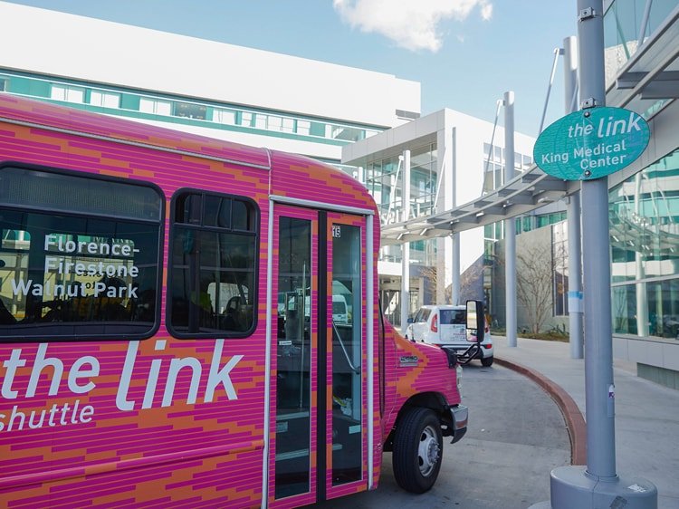 Close up of pink Link shuttle transport van
