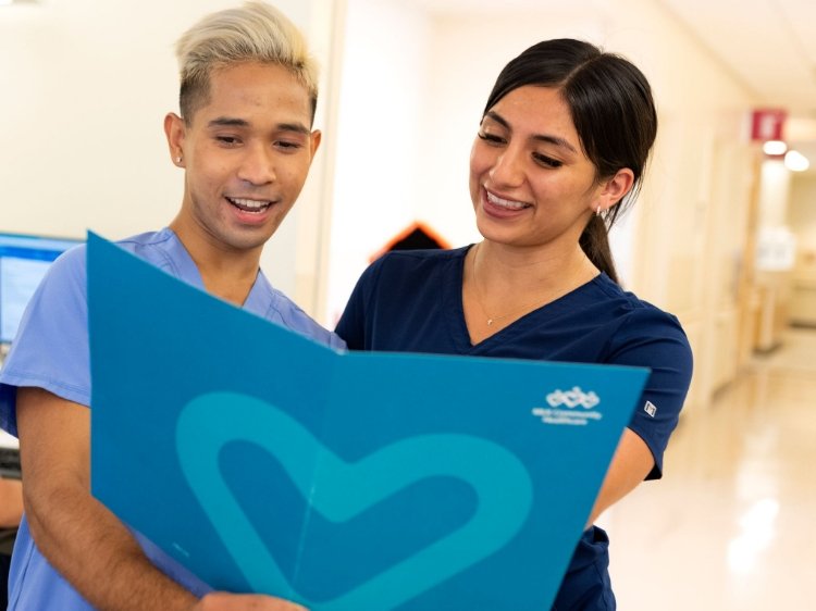 Photo of a male and female nurse looking at a folder