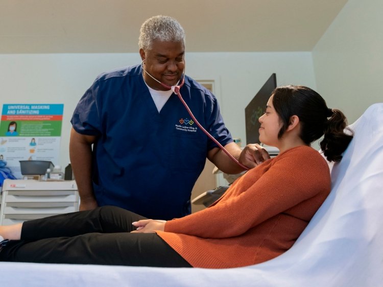 Photo of a male AA nurse with a Hispanic patient