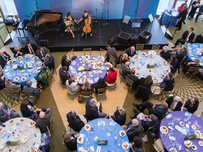Overhead shot of round tables laid out in blue and purple linens