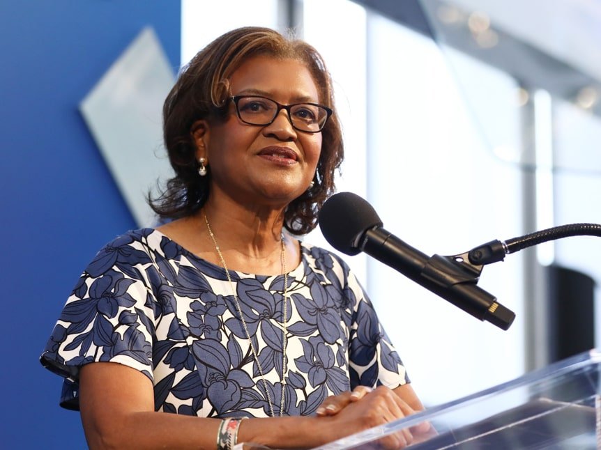 Close up of Dr. Batchlor, a middle-aged Black woman, at the Dream Lunch podium